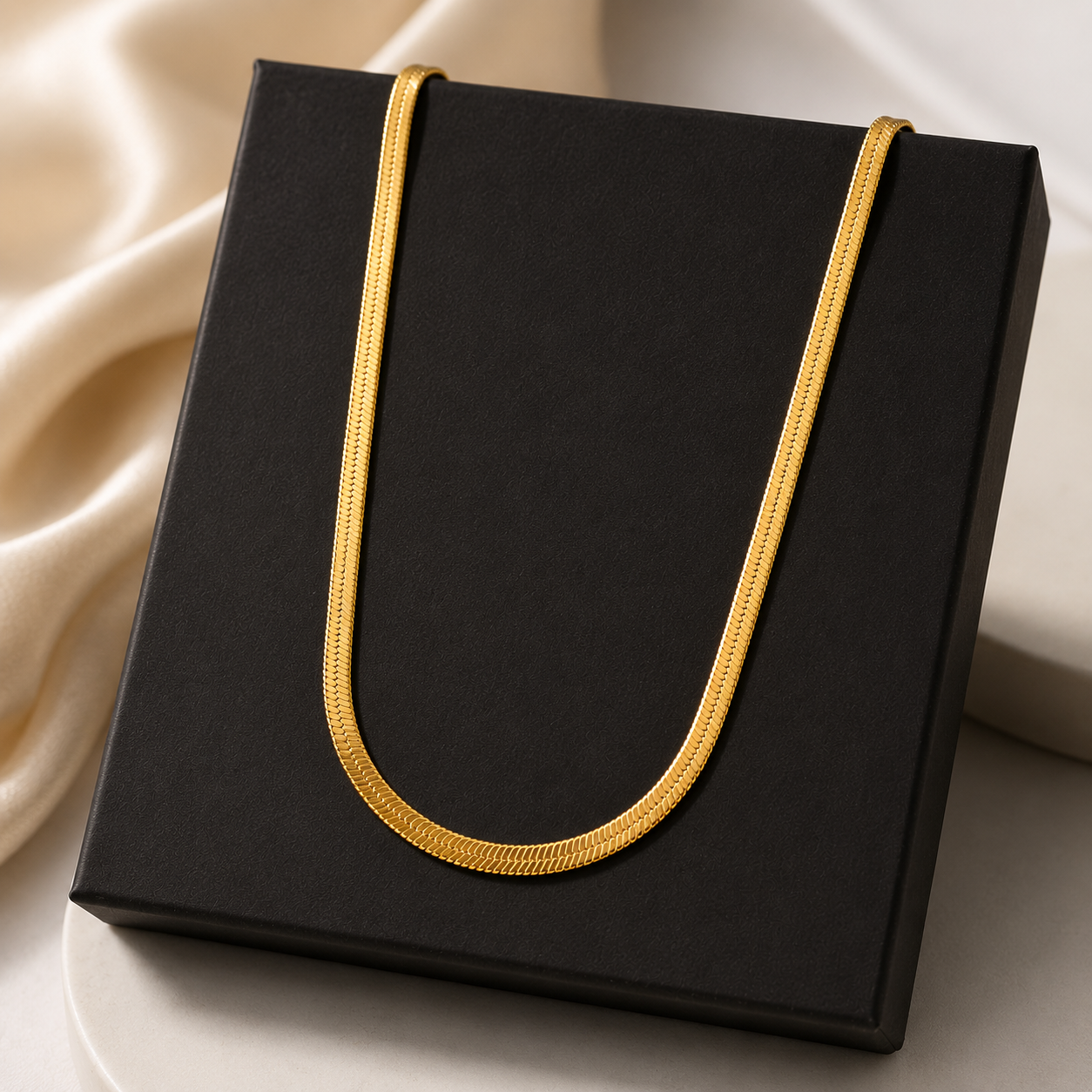 Black box with a gold handle on a beige fabric background