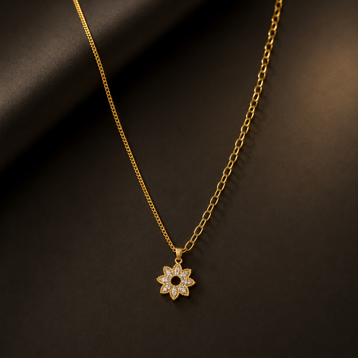 Gold necklace with a floral pendant on a dark background