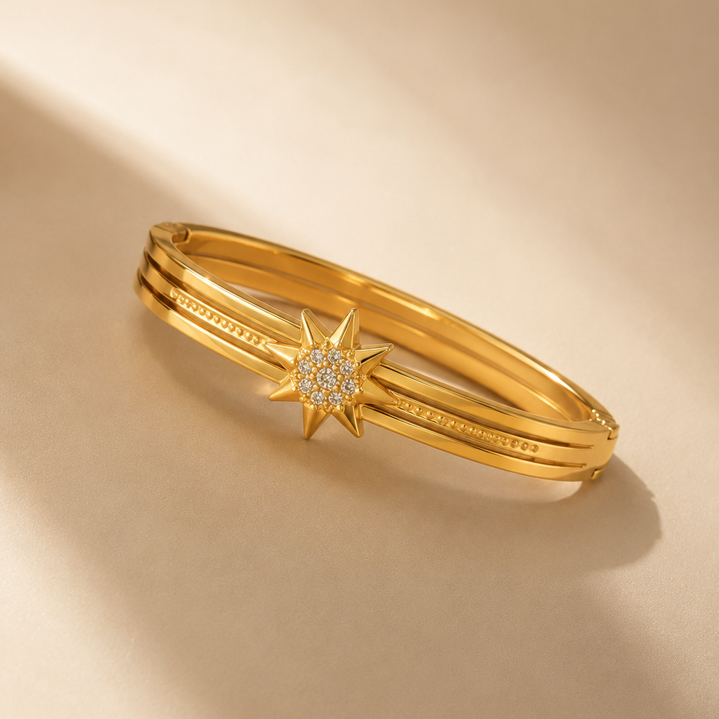 Gold bracelet with star design on a beige background