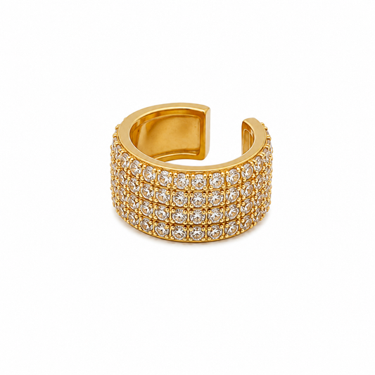 A wide gold-toned cuff ring set with three rows of clear pavé gemstones, photographed on a clean white background.