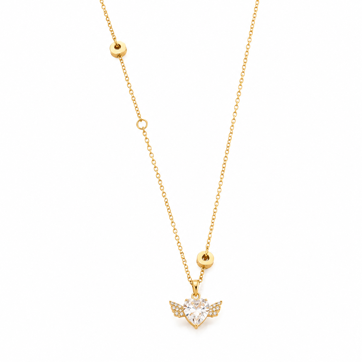 A delicate gold chain necklace featuring a small winged pendant with a heart-shaped clear gemstone pavé-set in a gold frame, displayed against a solid white background.