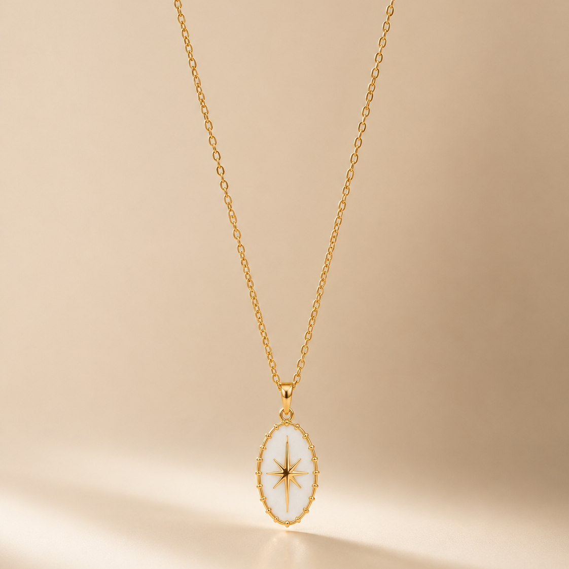 Gold necklace with a star pendant on a beige background
