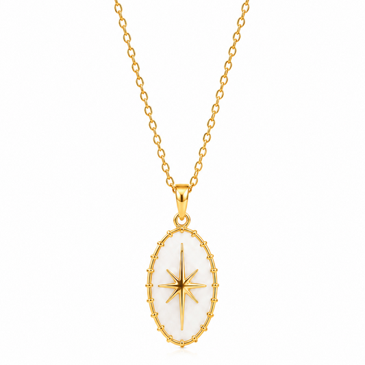 A gold chain necklace with an oval pendant featuring a white inlay and a gold compass rose design in the center, shown against a plain white background.