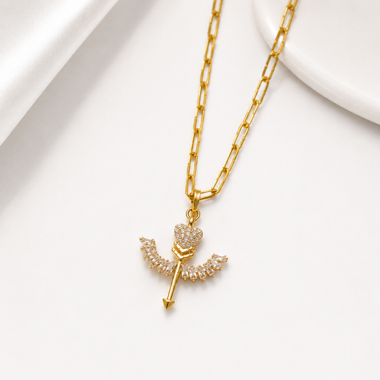 Gold necklace with a heart-shaped pendant on a white background