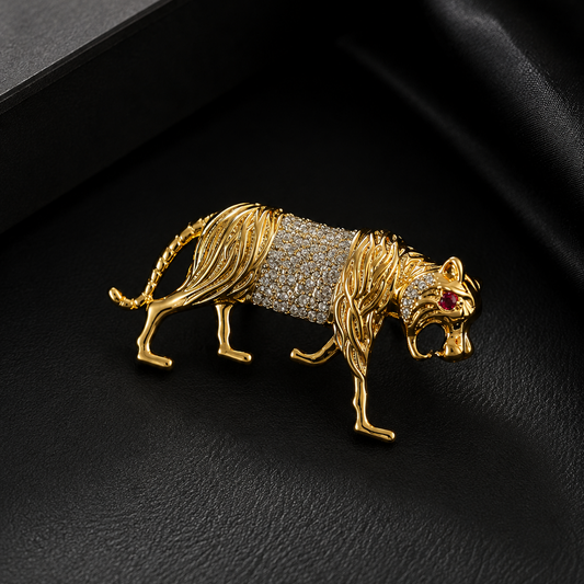 Gold tiger brooch with gemstones on a black background