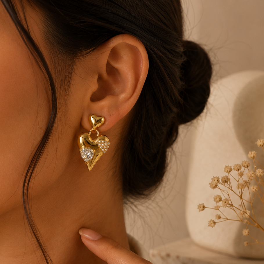 Close-up of a person wearing a gold heart-shaped earring with a blurred background