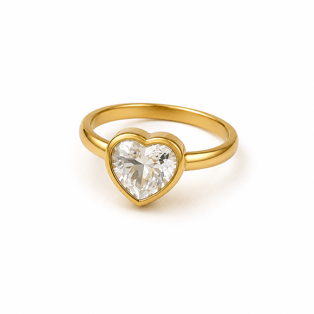 A gold heart-shaped ring featuring a clear heart-cut gemstone in a bezel setting, shown on a plain white background.