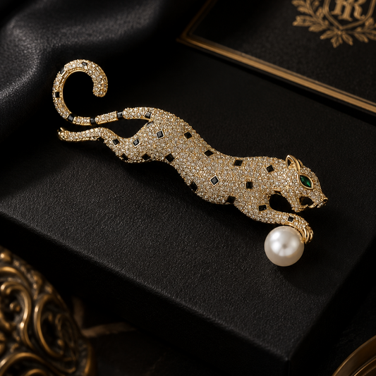 Gold panther brooch with pearl on a black background