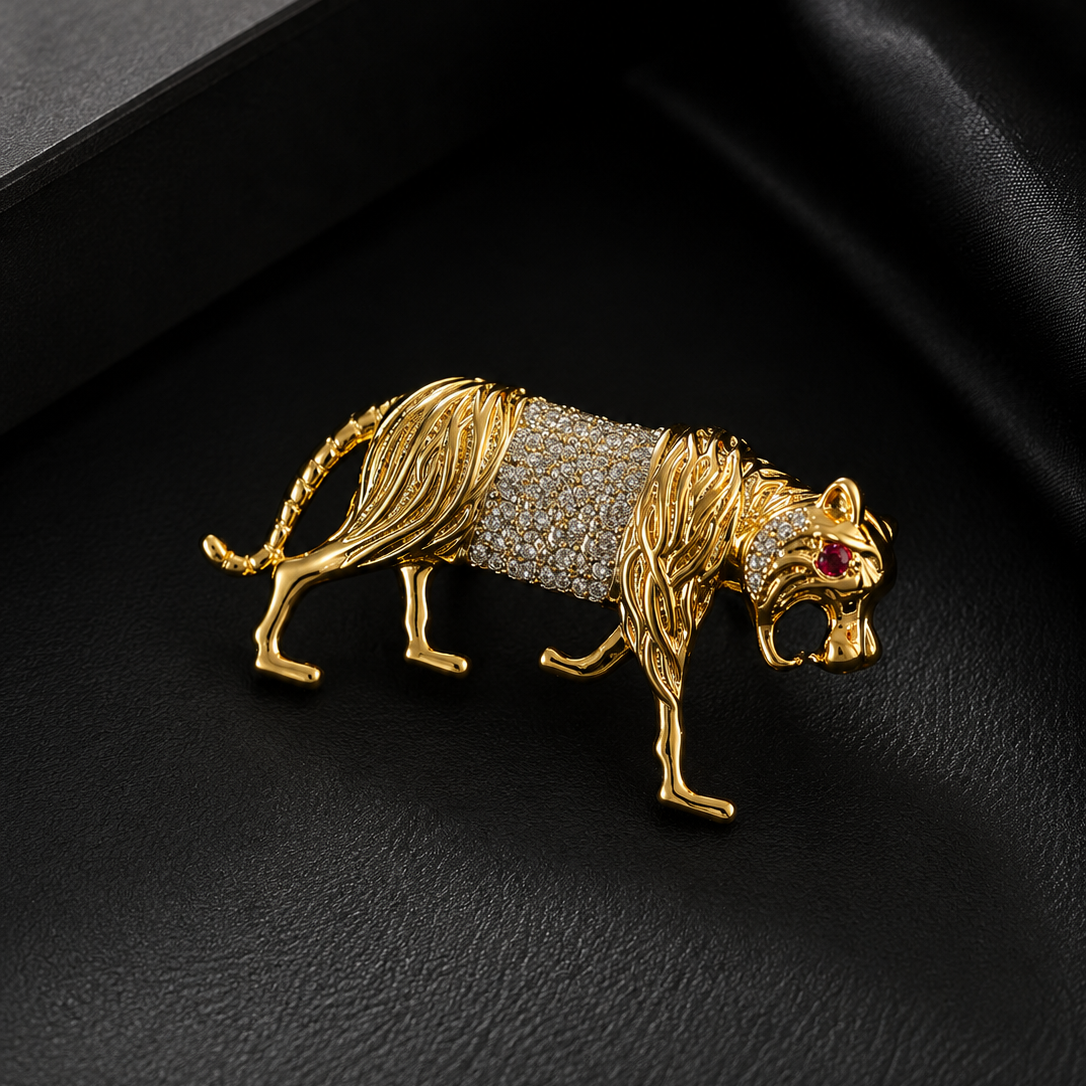 Gold tiger brooch with gemstone details on a black background