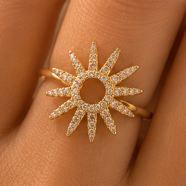 Gold sun-shaped ring with diamonds on a finger