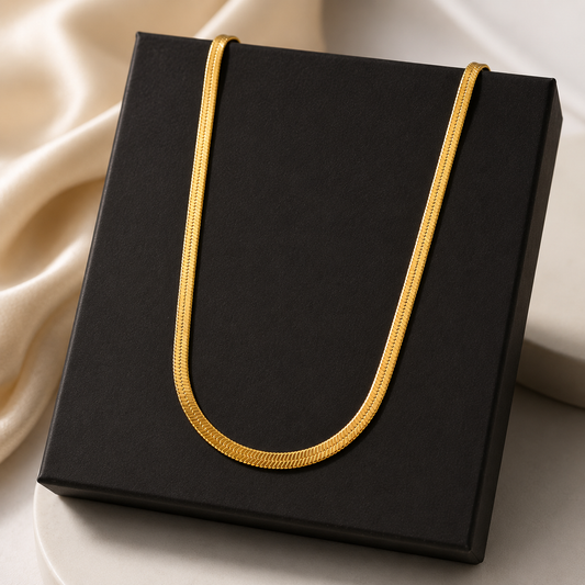 Black box with a gold handle on a beige fabric background