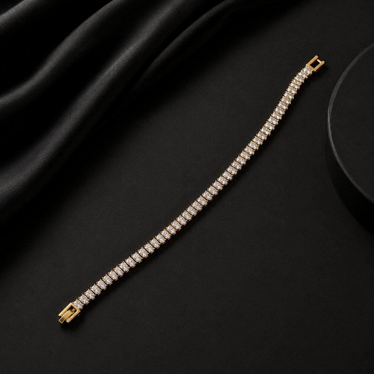 Gold bracelet with diamonds on a black fabric background